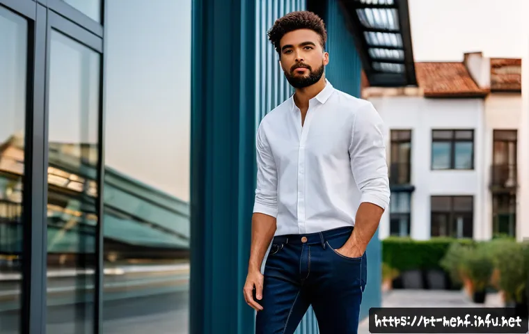 남성용 데님 브랜드 리뷰 - A stylish urban male model wearing a pair of slim-fit dark indigo jeans made from 100% organic cotto...